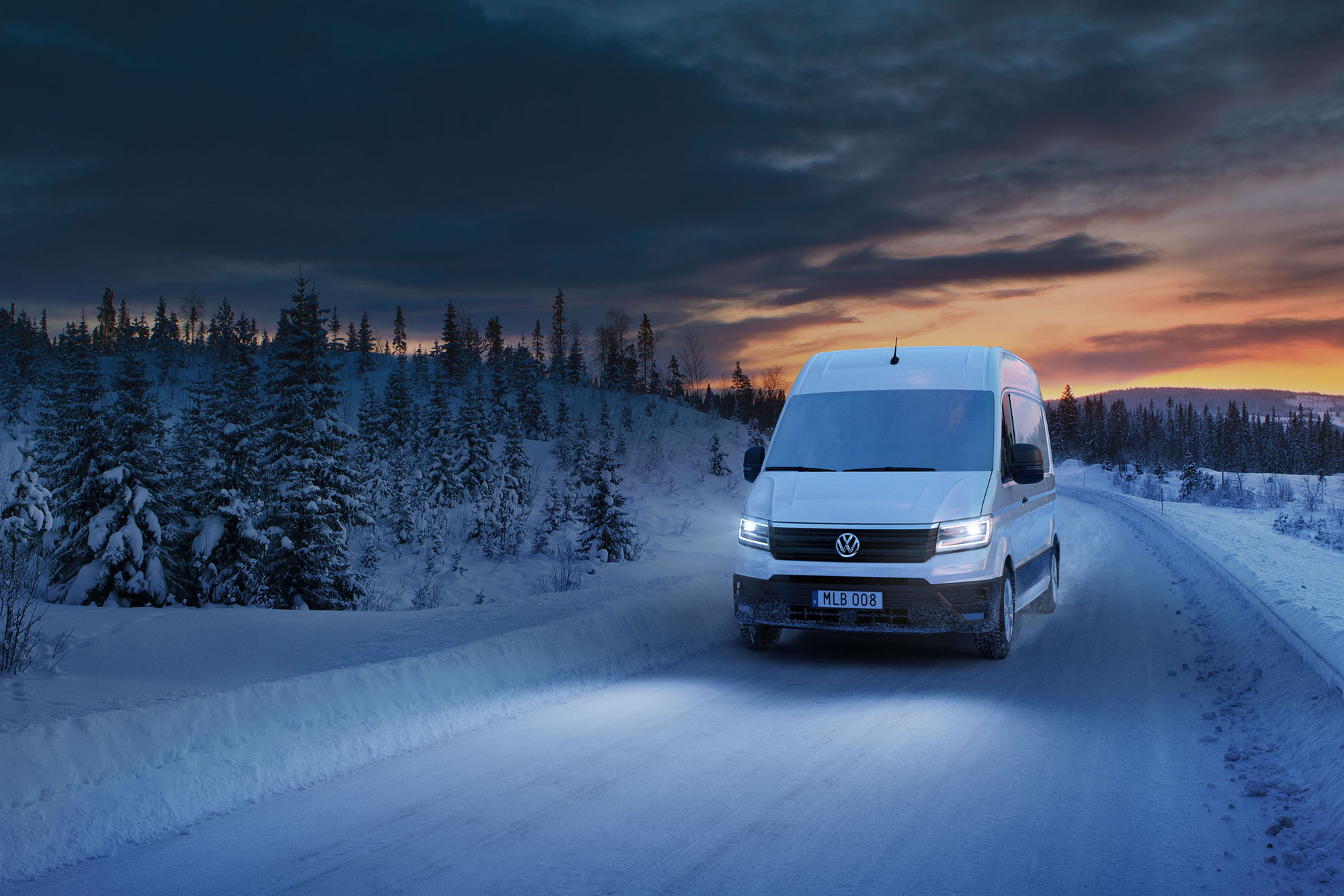 Volkswagen transportbilar Crafter driving on a snowy winter road in the night. Fjällen vinter väg snö